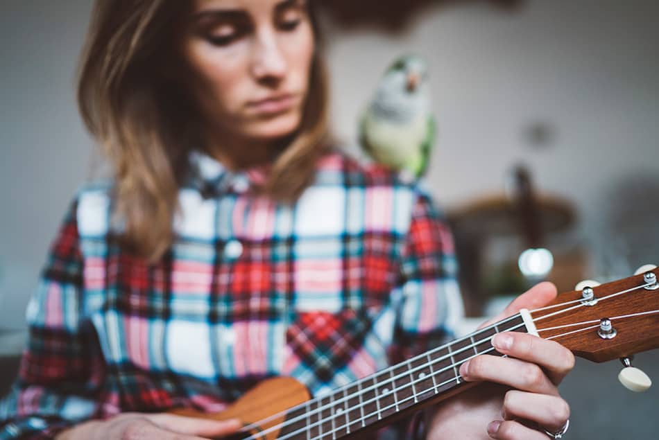 Woman learning to play ukulele